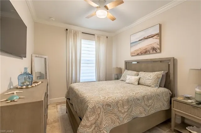 a bedroom with a bed and a flat tv screen on dresser