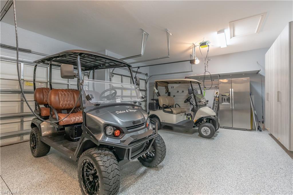9332 Fieldstone Lane Naples, FL 34120 - Photo 30 of 41 a car and bike parked in a garage