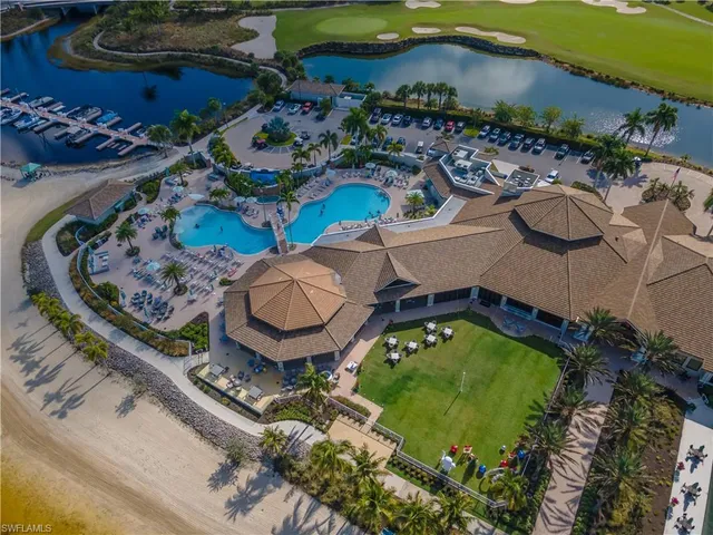 an aerial view of a house with swimming pool and outdoor seating