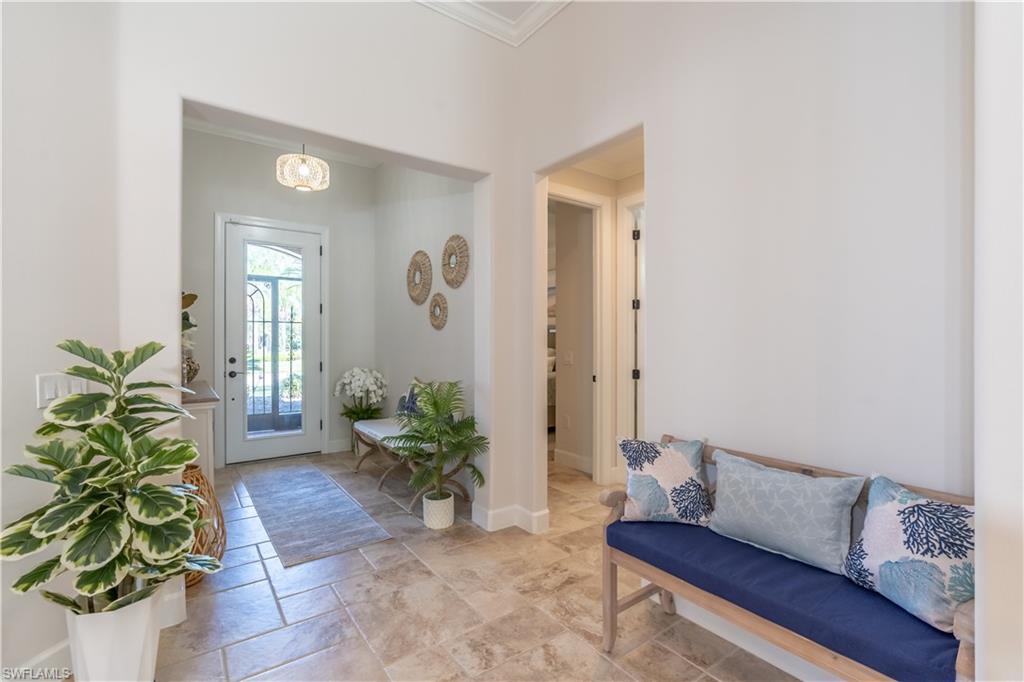 9332 Fieldstone Lane Naples, FL 34120 - Photo 5 of 41 a living room with furniture and a potted plant
