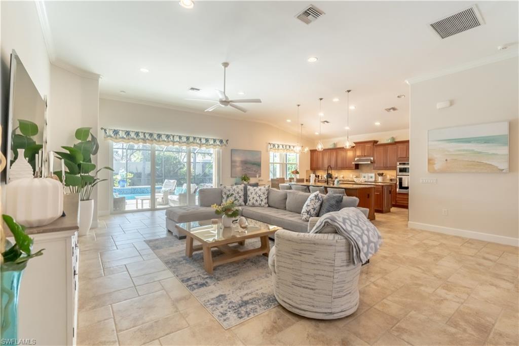 9332 Fieldstone Lane Naples, FL 34120 - Photo 8 of 41 a living room with furniture and a flat screen tv