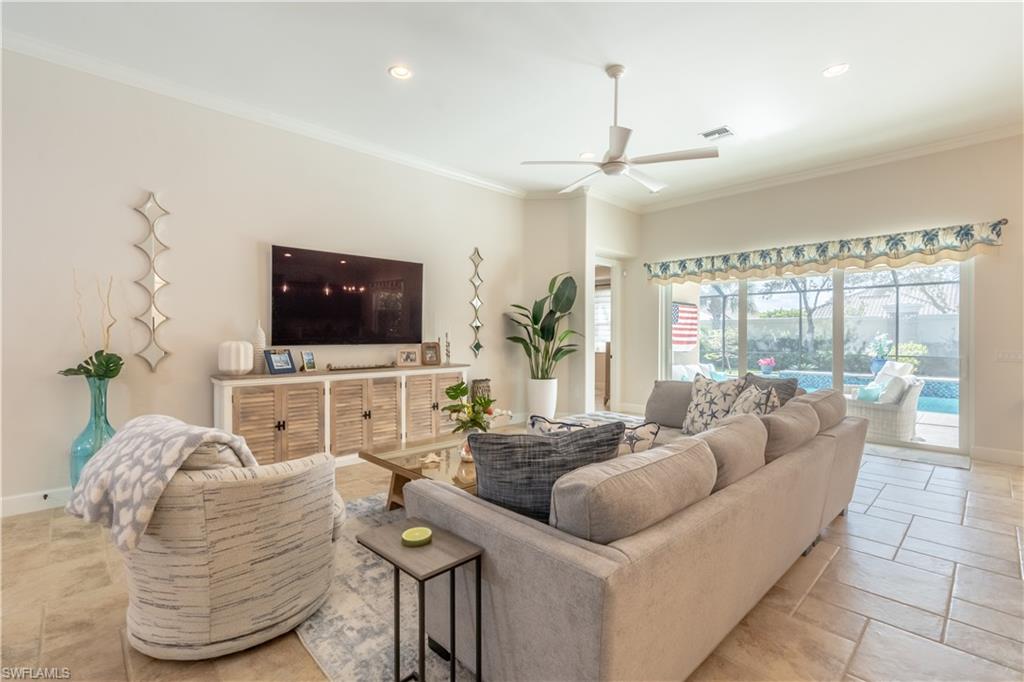 9332 Fieldstone Lane Naples, FL 34120 - Photo 10 of 41 a living room with furniture and a flat screen tv