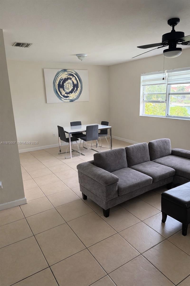1485 Northeast 33rd Road, Unit 207 Homestead, FL 33033 - Photo 2 of 10 a living room with furniture and a window