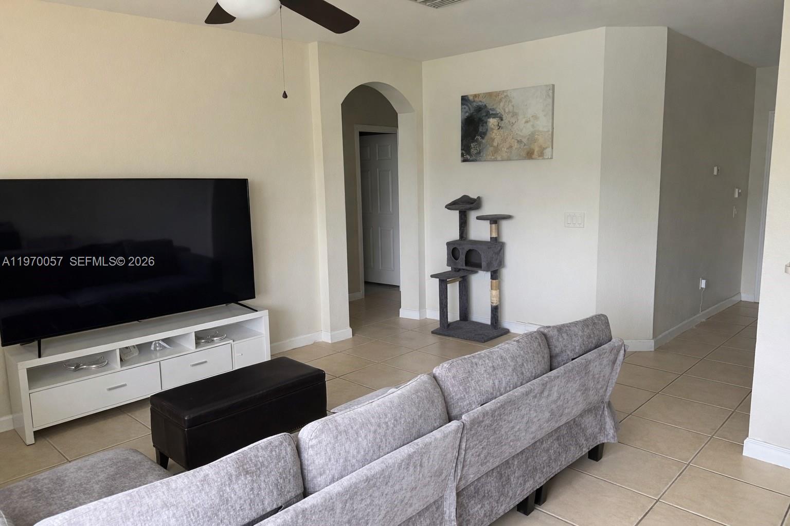 1485 Northeast 33rd Road, Unit 207 Homestead, FL 33033 - Photo 4 of 10 a living room with furniture and a flat screen tv