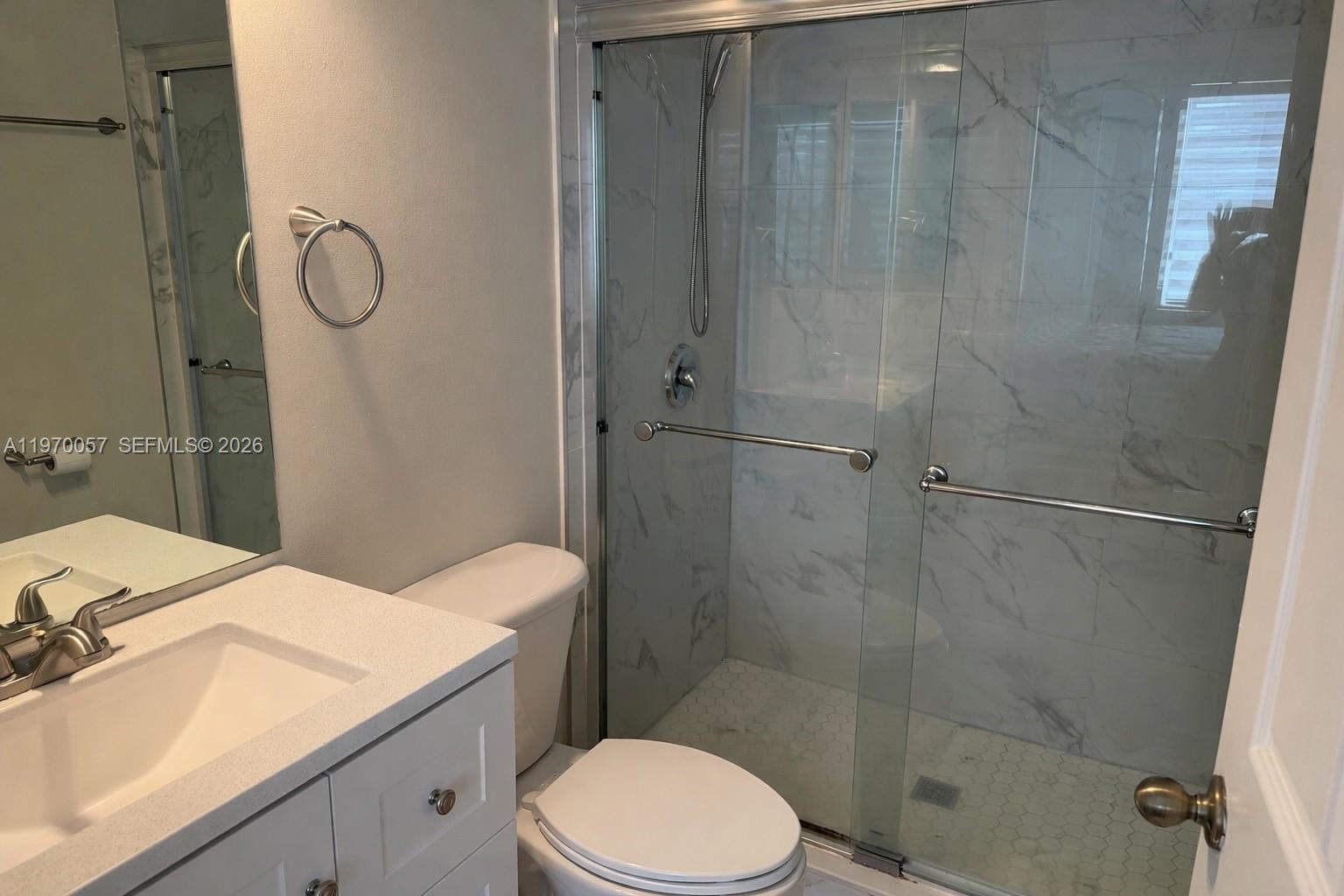 1485 Northeast 33rd Road, Unit 207 Homestead, FL 33033 - Photo 7 of 10 a bathroom with a granite countertop sink toilet and shower