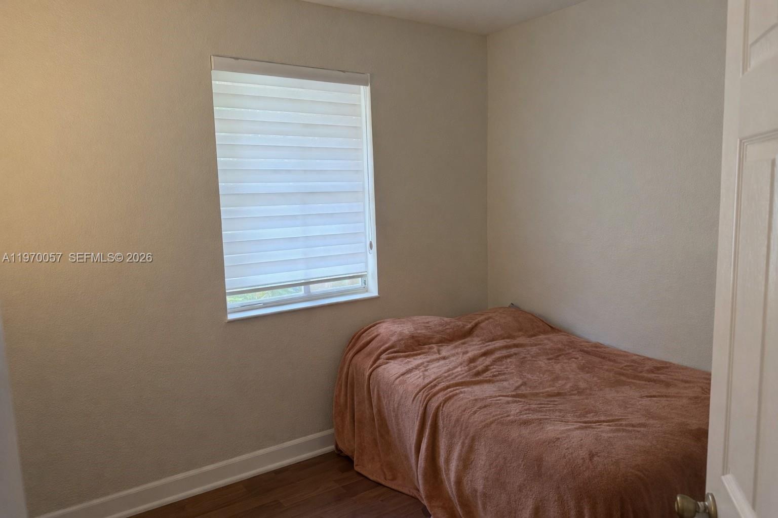 1485 Northeast 33rd Road, Unit 207 Homestead, FL 33033 - Photo 8 of 10 a bedroom with a bed and a window