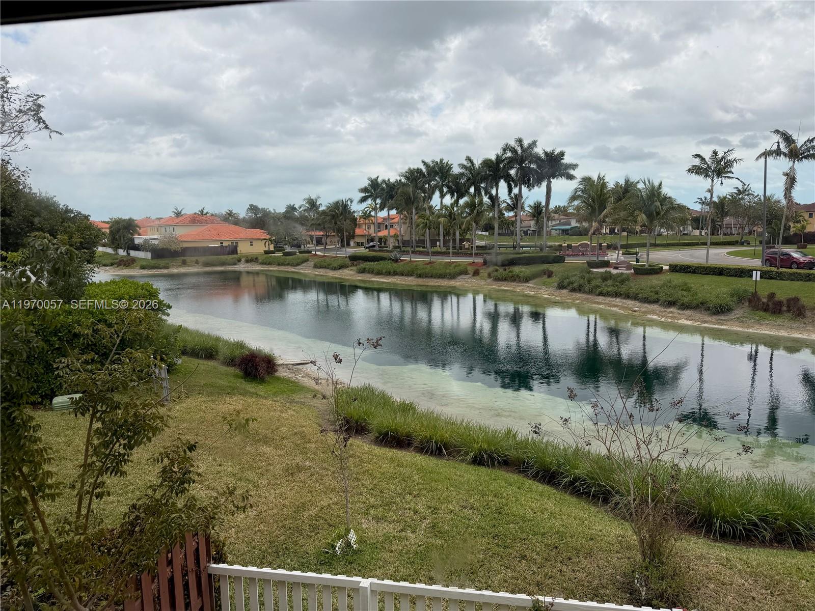 1485 Northeast 33rd Road, Unit 207 Homestead, FL 33033 - Photo 10 of 10 a view of a lake with houses in the back