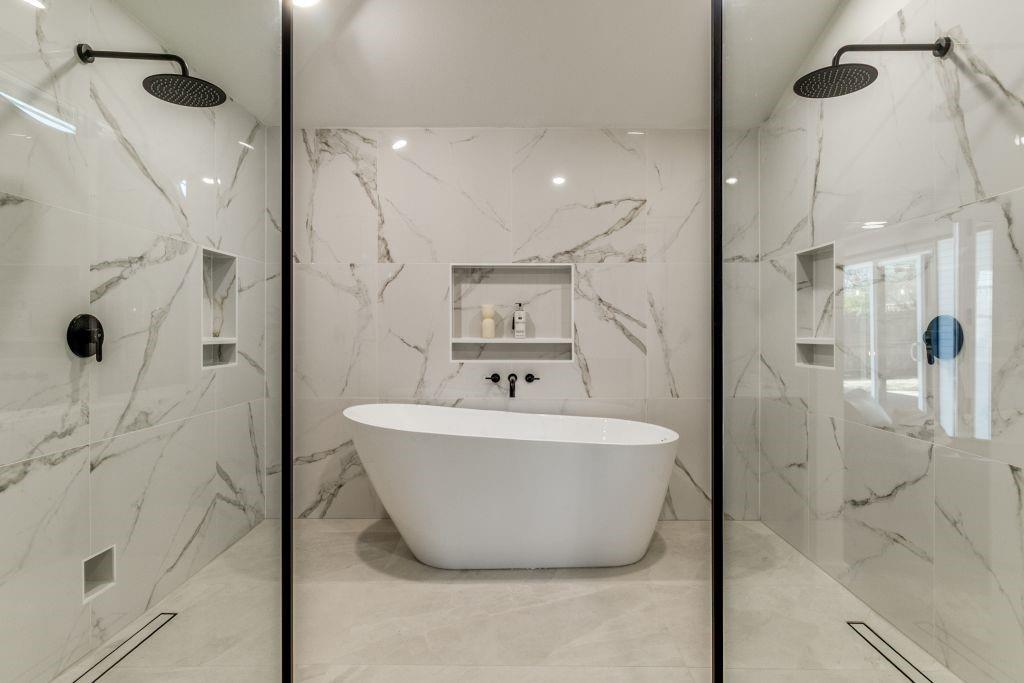 a bathroom with a bathtub and shower