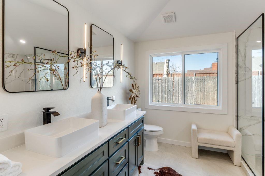 3121 Damascus Way Farmers Branch, TX 75234 - Photo 22 of 25 a bathroom with a double vanity sink toilet and mirror