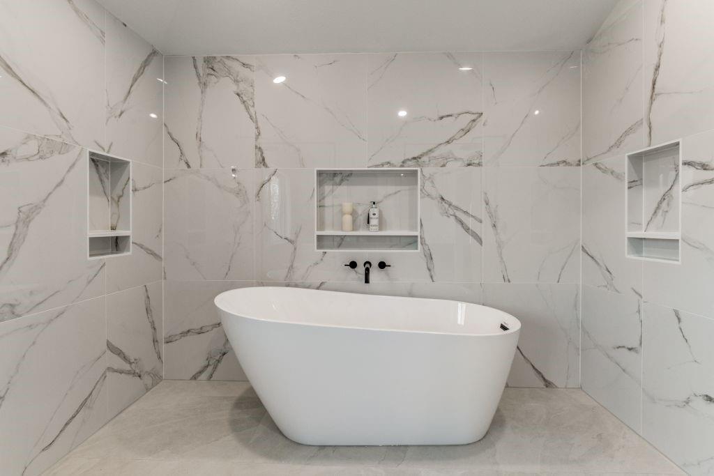 3121 Damascus Way Farmers Branch, TX 75234 - Photo 23 of 25 a white bath tub sitting in a bathroom