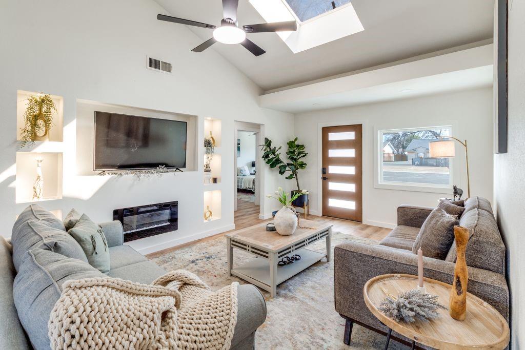 3121 Damascus Way Farmers Branch, TX 75234 - Photo 5 of 25 a living room with furniture a flat screen tv and a fireplace