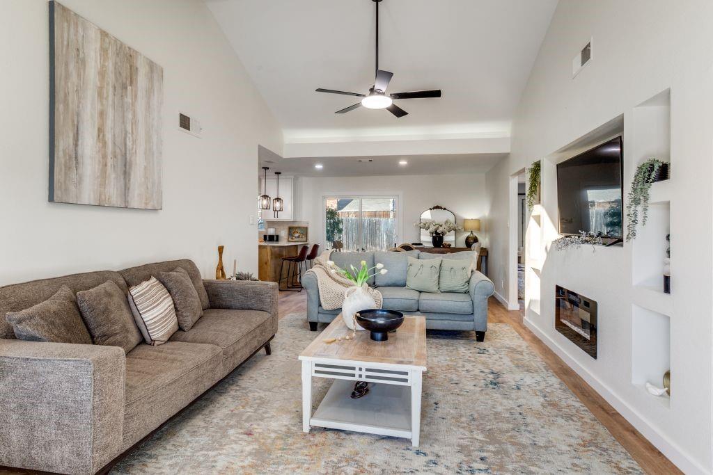 3121 Damascus Way Farmers Branch, TX 75234 - Photo 7 of 25 a living room with furniture a flat screen tv and a fireplace
