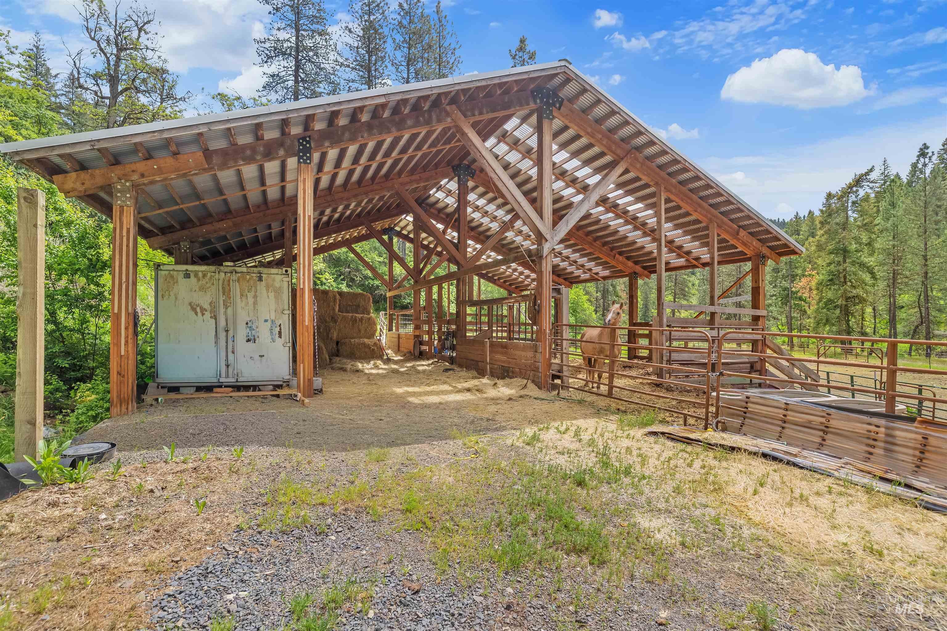 1314 Cedar Ridge Road Kendrick, ID 83537 - Photo 38 of 50 Open-air barn structure featuring a corrugated metal roof and exposed timber framing