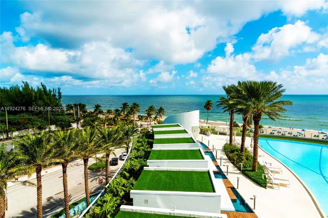 a living room with furniture a chandelier and a large window
