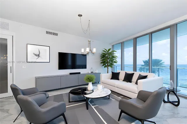 a living room with furniture flat screen tv and a large window