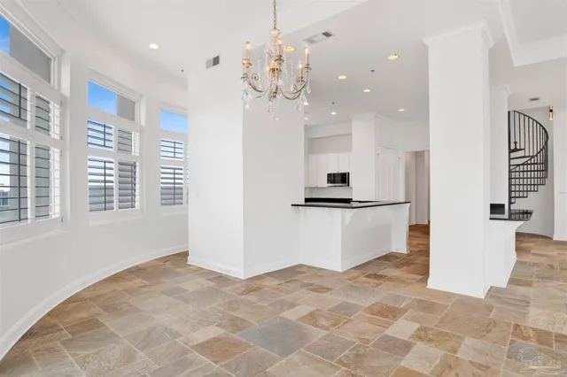 a kitchen with white cabinets white stainless steel appliances and sink