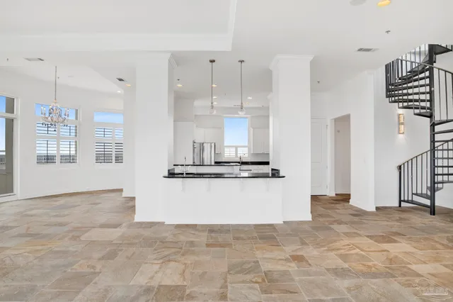 a living room with furniture a chandelier and fireplace