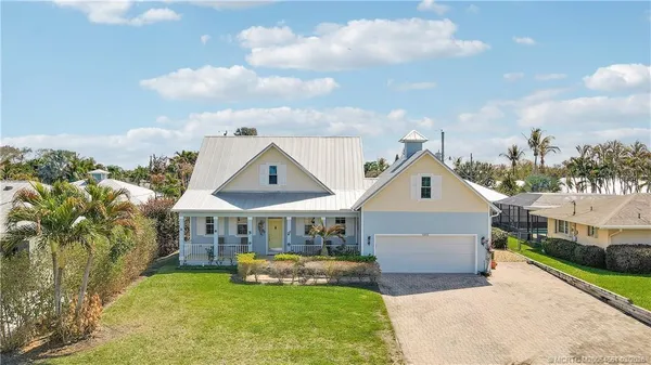 a front view of a house with a yard table and chairs