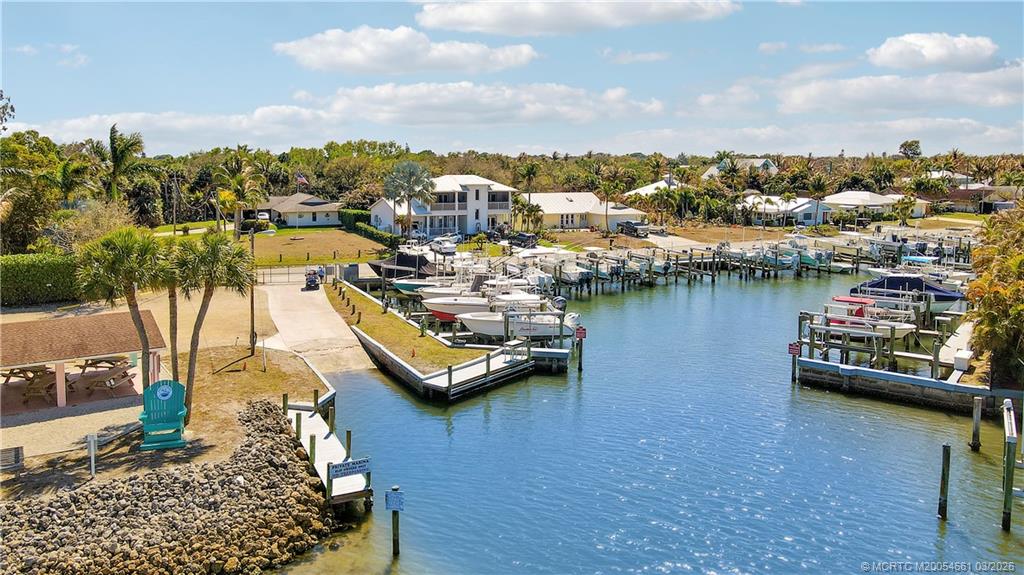 5352 Southeast Nassau Terrace Stuart, FL 34997 - Photo 12 of 53 a view of a lake with boats and trees in the background