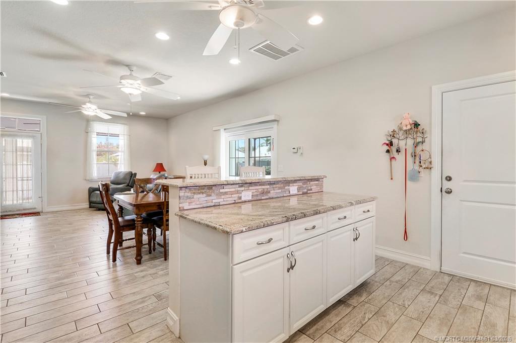 5352 Southeast Nassau Terrace Stuart, FL 34997 - Photo 19 of 53 a kitchen with a table and chairs in it