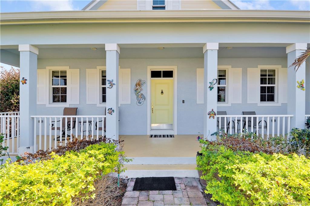 5352 Southeast Nassau Terrace Stuart, FL 34997 - Photo 2 of 53 a front view of a house with a garden
