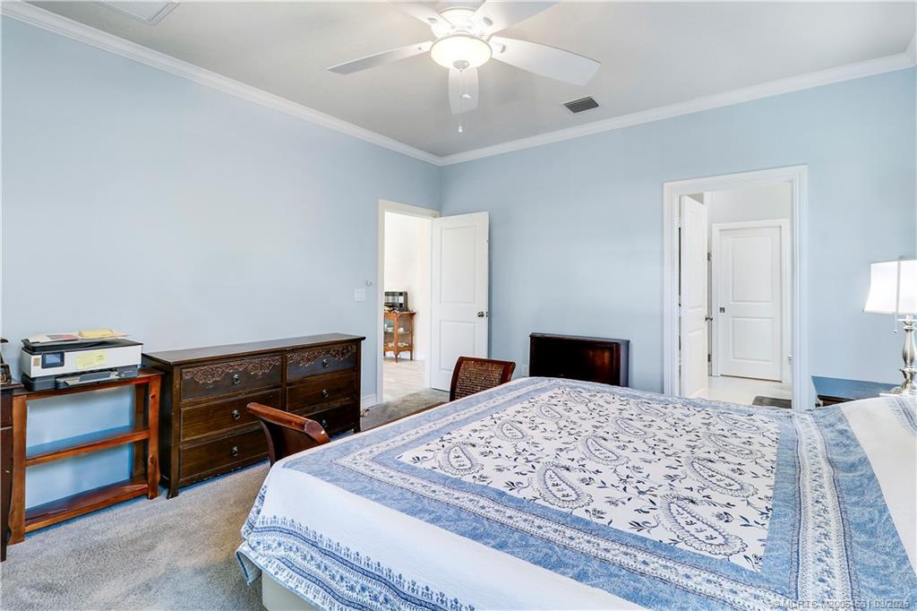 5352 Southeast Nassau Terrace Stuart, FL 34997 - Photo 28 of 53 a bedroom with a bed and a dresser