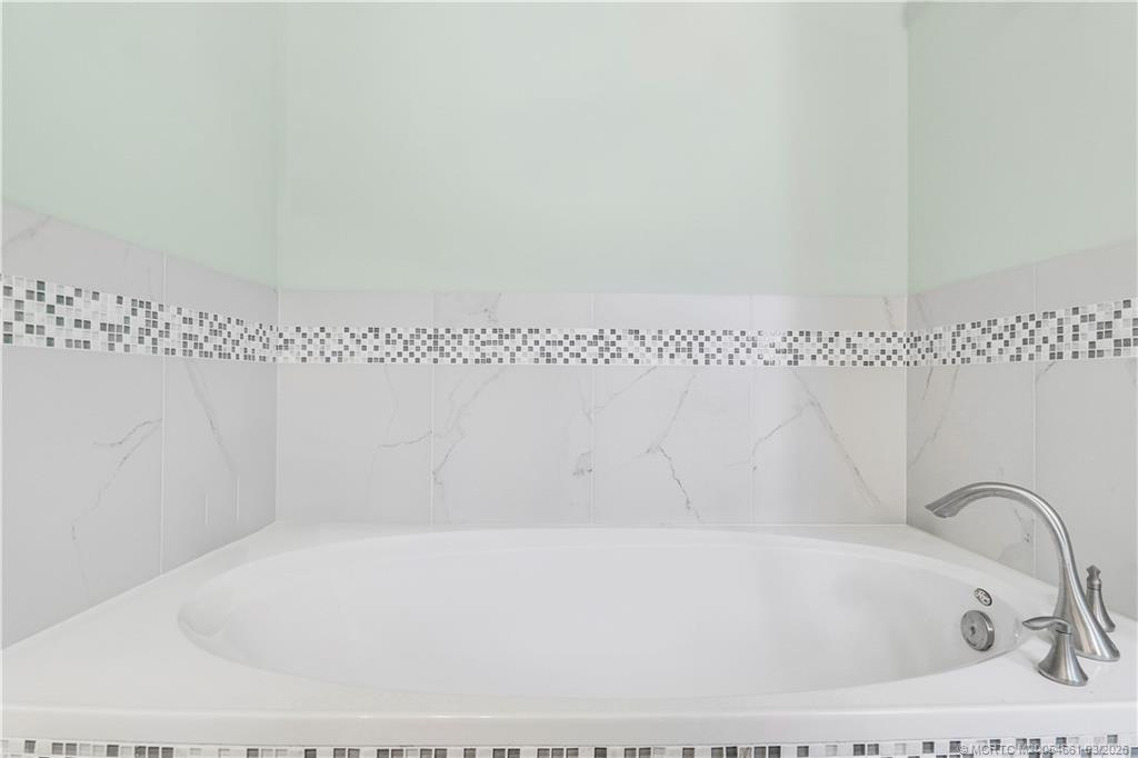 5352 Southeast Nassau Terrace Stuart, FL 34997 - Photo 30 of 53 a bathroom with a bathtub