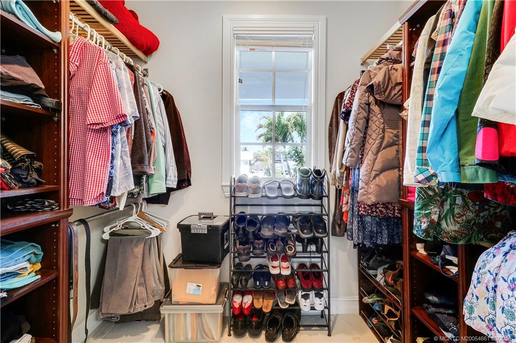5352 Southeast Nassau Terrace Stuart, FL 34997 - Photo 32 of 53 a view of walk in closet with clothes and shoes