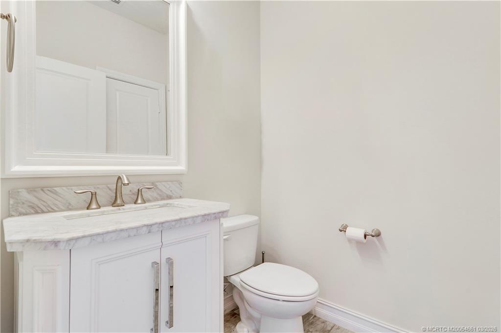 5352 Southeast Nassau Terrace Stuart, FL 34997 - Photo 33 of 53 a bathroom with a sink and a toilet