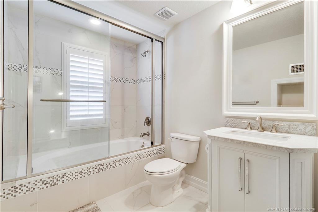 5352 Southeast Nassau Terrace Stuart, FL 34997 - Photo 39 of 53 a bathroom with a sink a toilet and shower