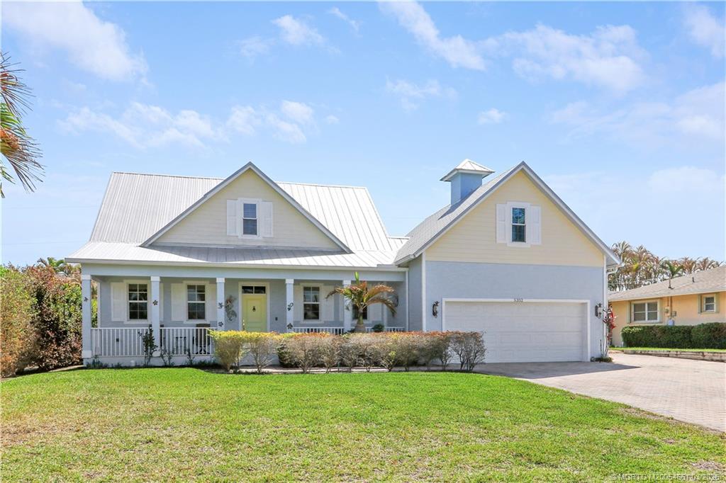 5352 Southeast Nassau Terrace Stuart, FL 34997 - Photo 51 of 53 a front view of a house with a garden