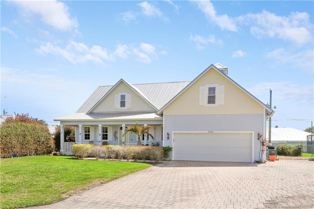 5352 Southeast Nassau Terrace Stuart, FL 34997 - Photo 53 of 53 a front view of a house with a garden and yard