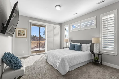 a bedroom with a bed and a couch