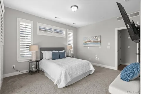 a bedroom with a large bed and a window