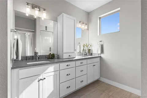 a bathroom with a granite countertop sink mirror and double