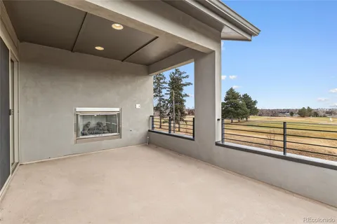 a view of an empty room with a window and a ceiling fan