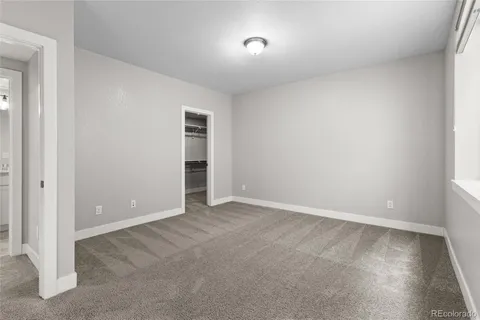 an empty room with closet and a window