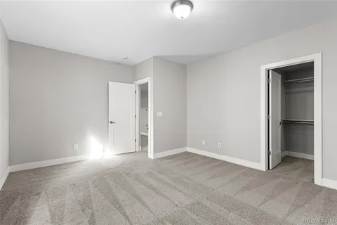 a view of a balcony with two chairs and a ceiling fan