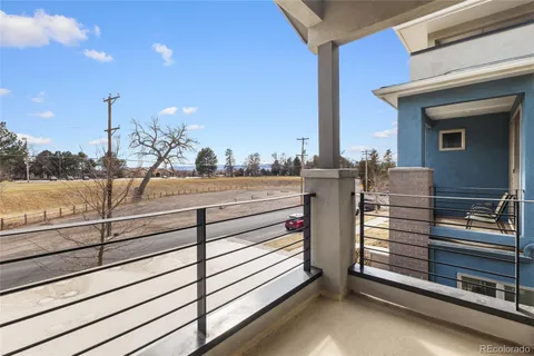a view of a patio with couches chairs and wooden floor