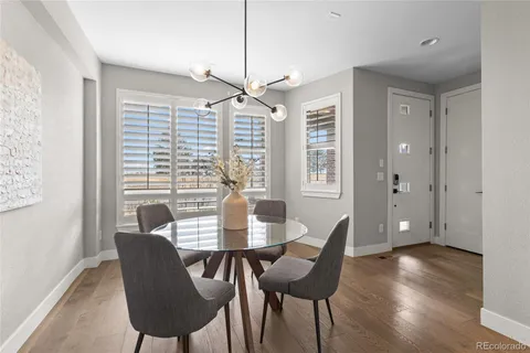 a dining room with furniture and wooden floor