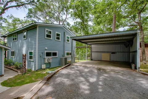 a view of house with backyard and a garden