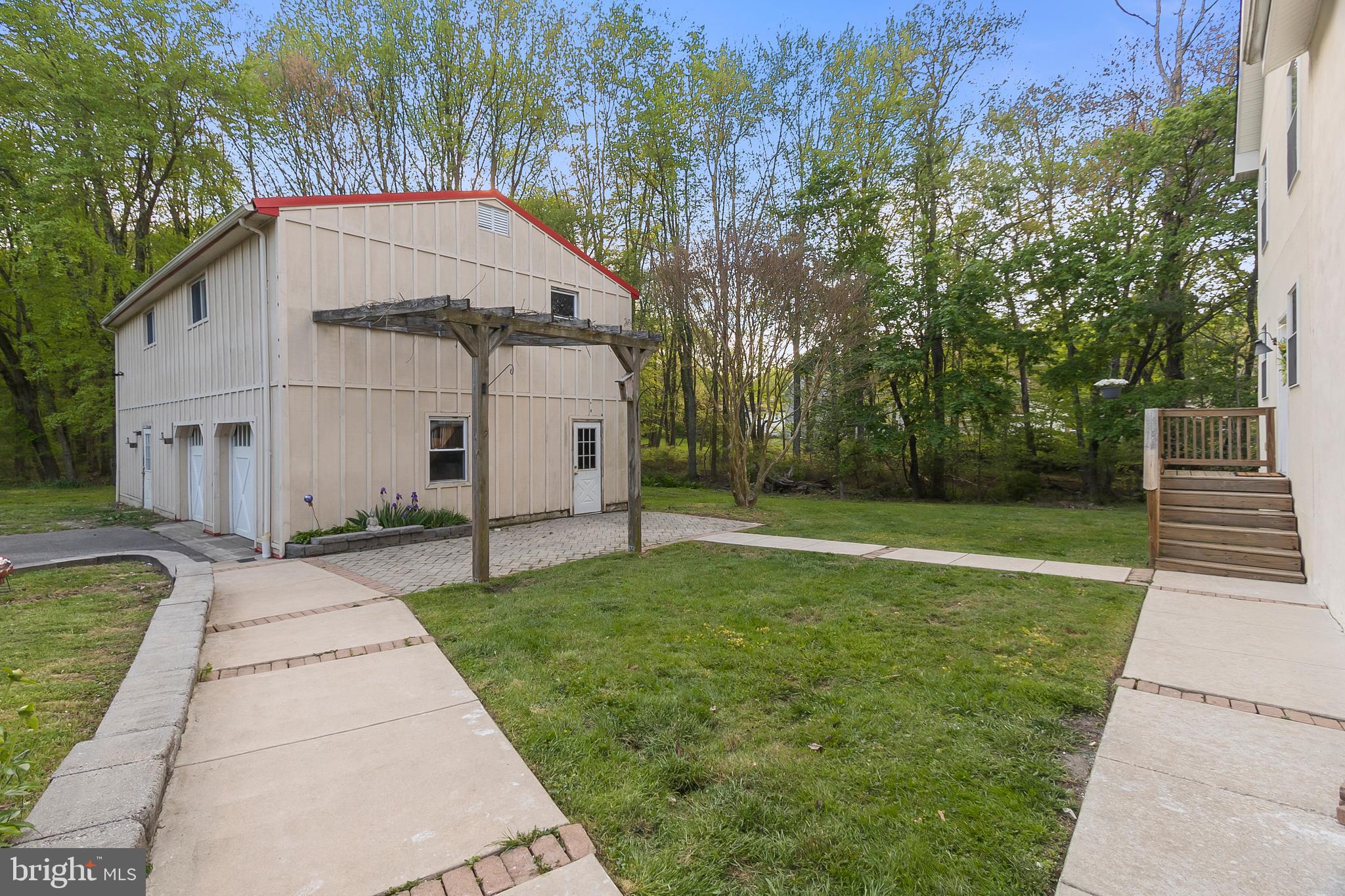1027 Kirk Road Garnet Valley, PA 19060 - Photo 62 of 63 Trees behind the garage and house lead to a stream