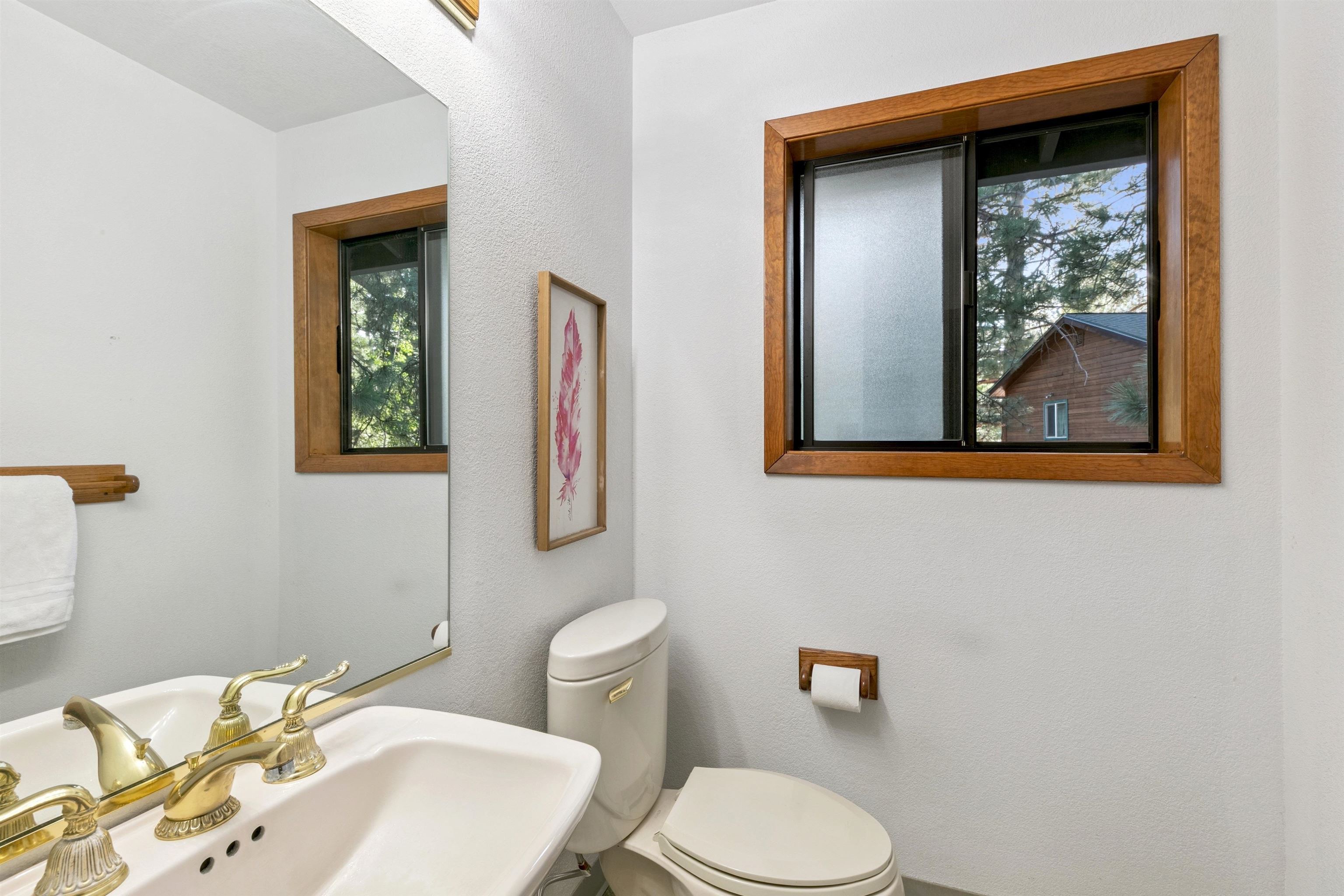 10625 Royal Crest Drive Truckee, CA 96161 - Photo 17 of 28 a bathroom with a toilet sink and mirror