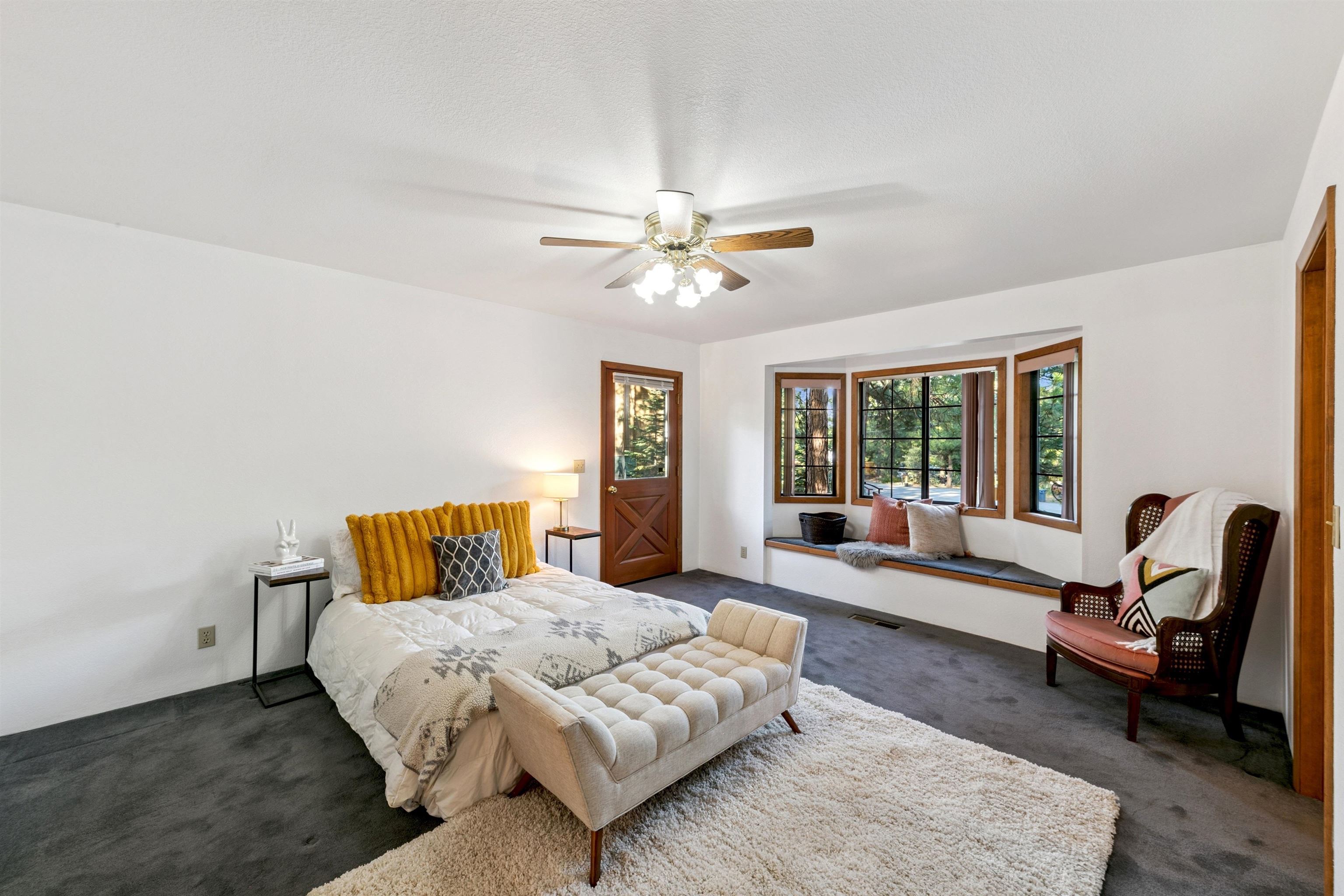 10625 Royal Crest Drive Truckee, CA 96161 - Photo 18 of 28 a bedroom with a bed a couch and a chandelier