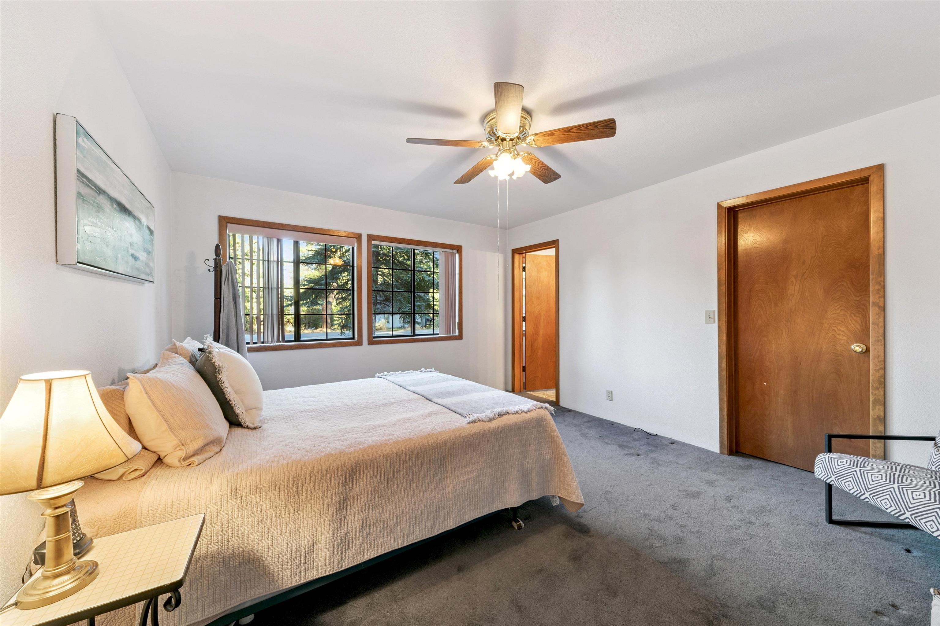 10625 Royal Crest Drive Truckee, CA 96161 - Photo 25 of 28 a bedroom with a large bed and a chandelier
