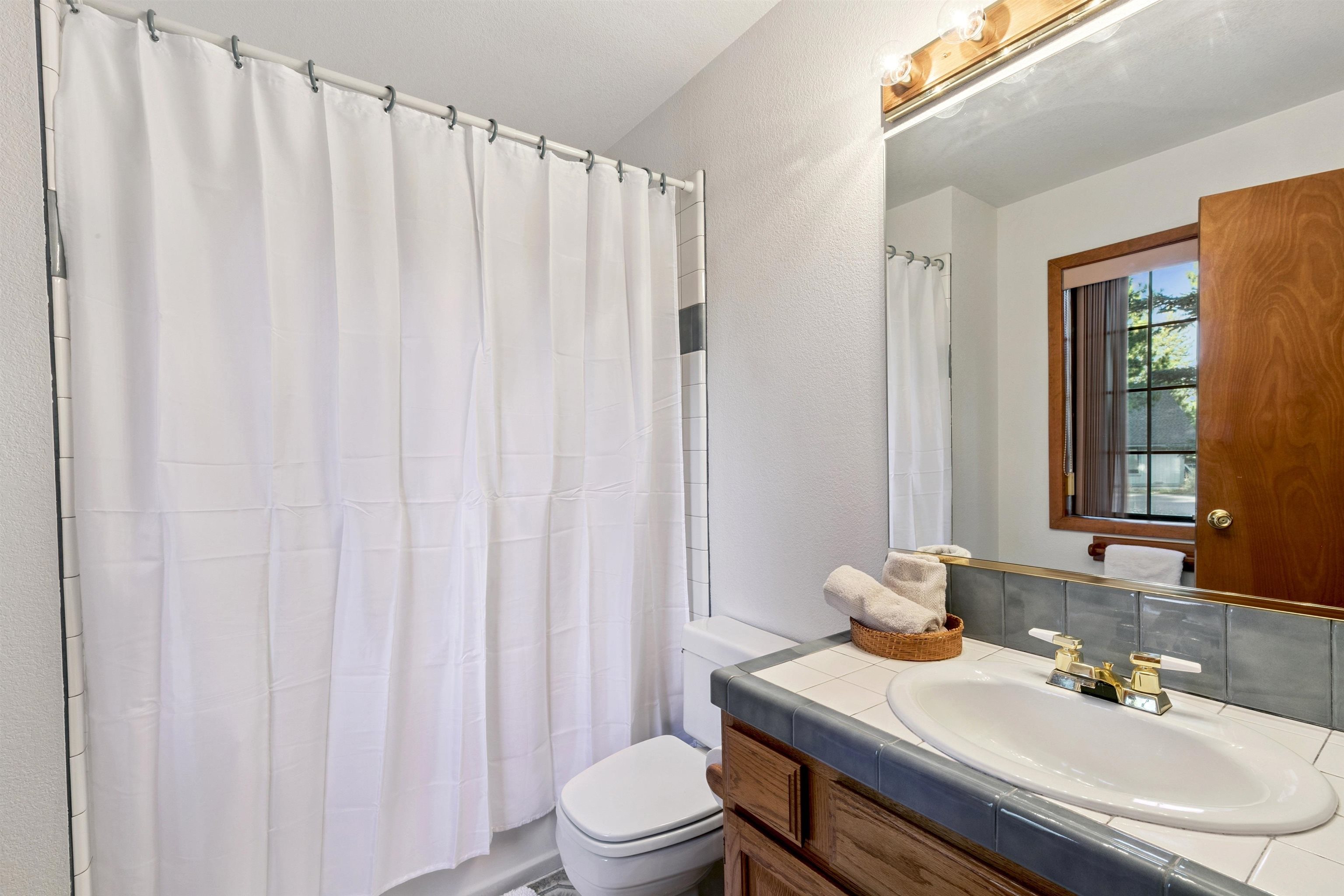 10625 Royal Crest Drive Truckee, CA 96161 - Photo 26 of 28 a bathroom with a sink toilet and mirror