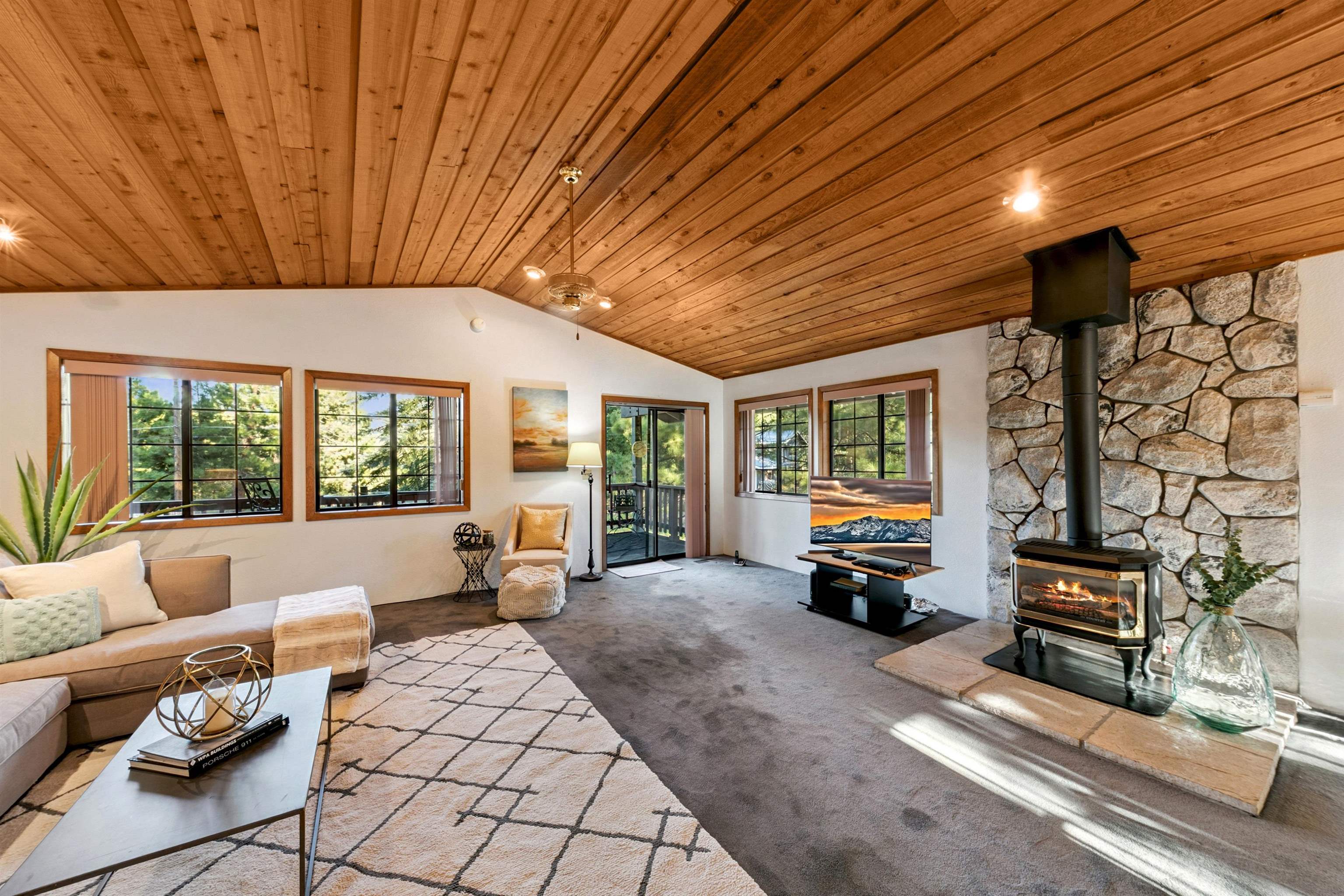 10625 Royal Crest Drive Truckee, CA 96161 - Photo 8 of 28 a living room with furniture a flat screen tv and floor to ceiling window