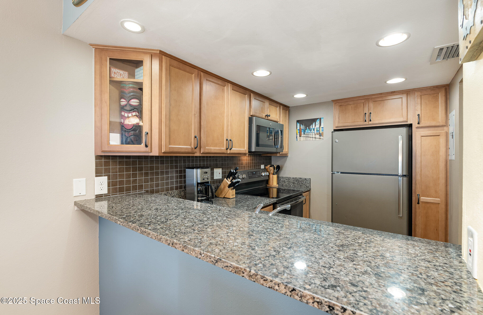 5350 Ocean Beach Boulevard, Unit 211 Cocoa Beach, FL 32931 - Photo 17 of 37 a kitchen with refrigerator and sink