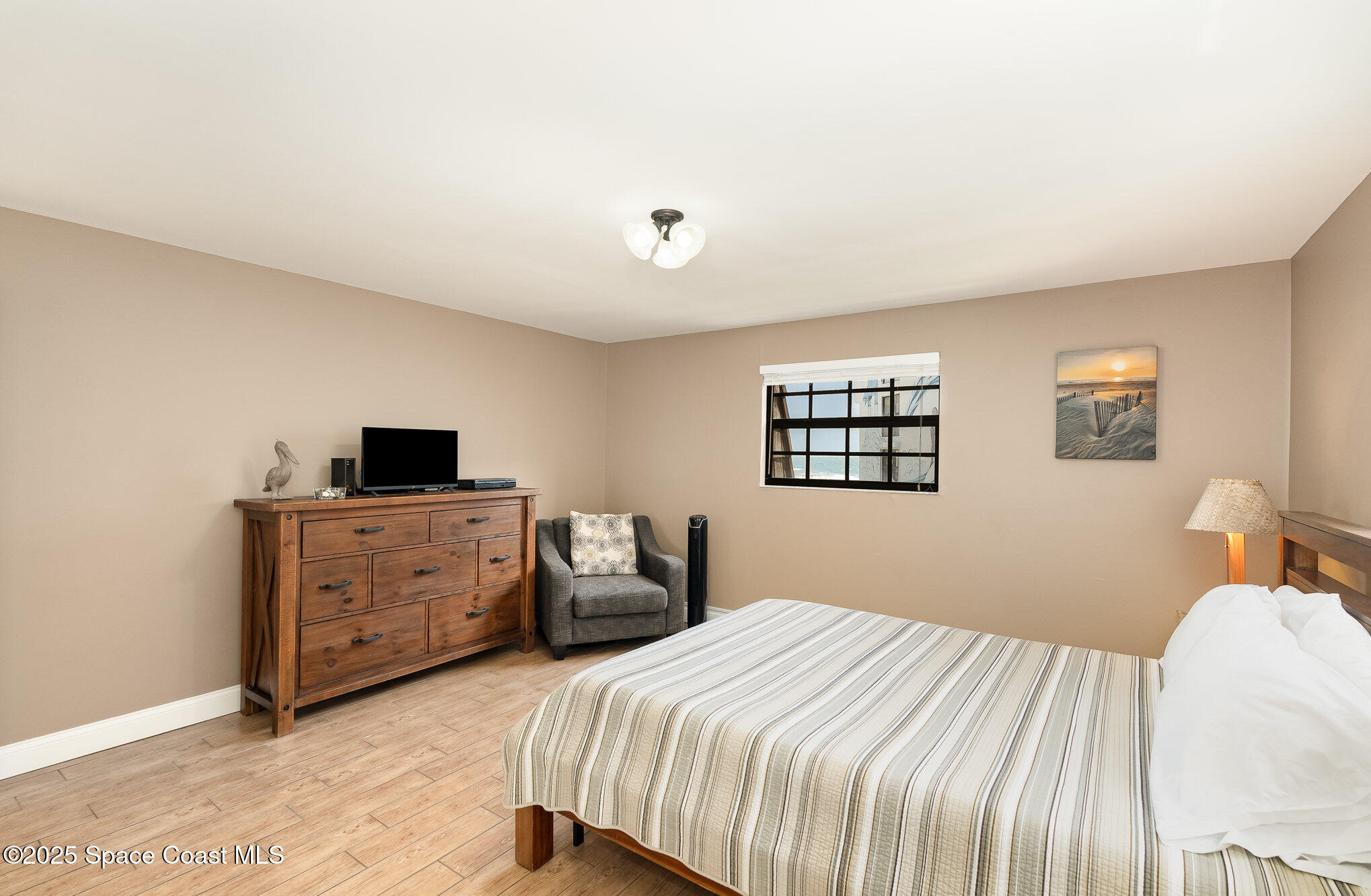 5350 Ocean Beach Boulevard, Unit 211 Cocoa Beach, FL 32931 - Photo 21 of 37 a bedroom with a bed and a desk