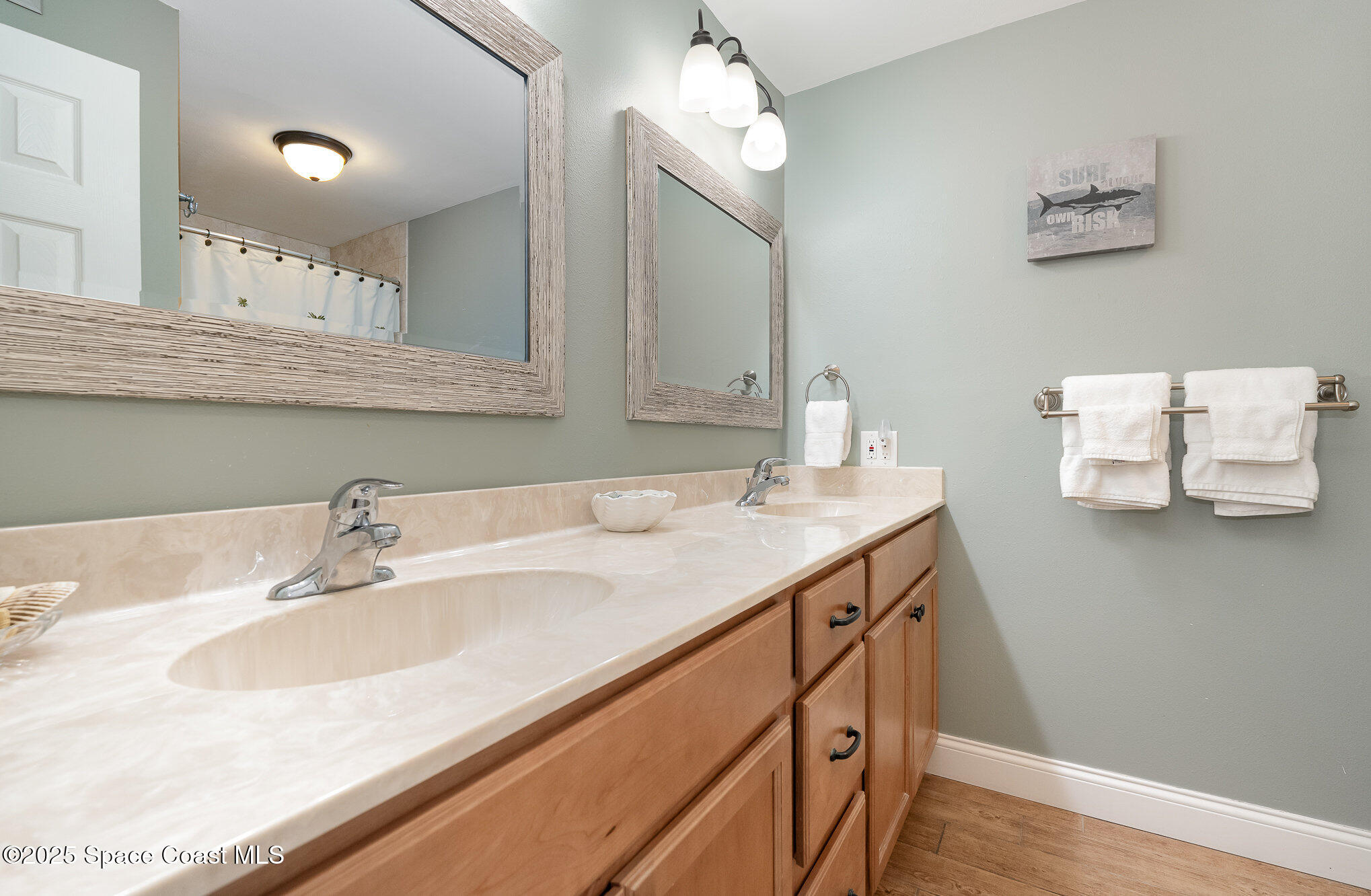 5350 Ocean Beach Boulevard, Unit 211 Cocoa Beach, FL 32931 - Photo 22 of 37 a bathroom with a sink and a mirror